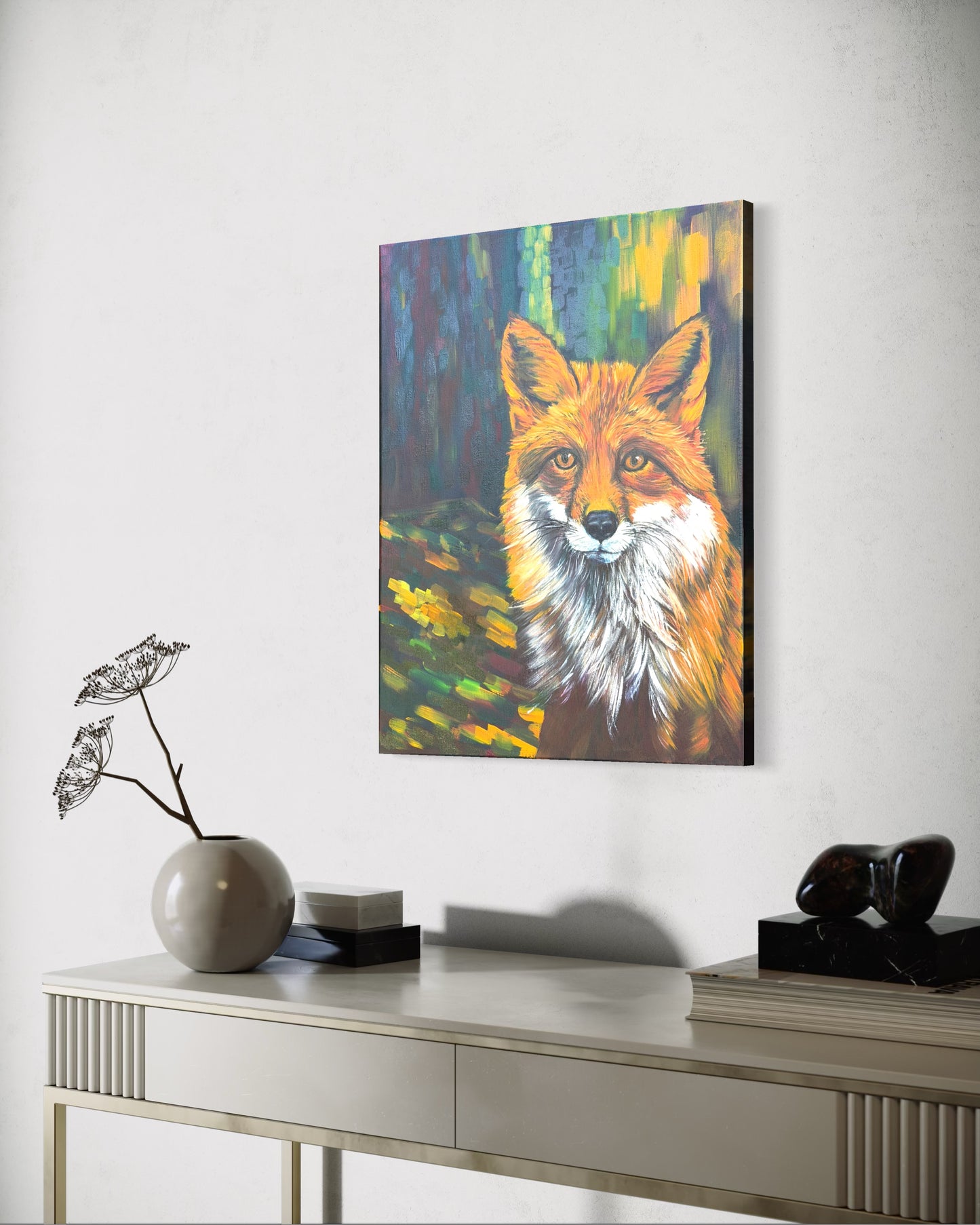 Colorful oil painting of a red fox on a wall above a console table.
