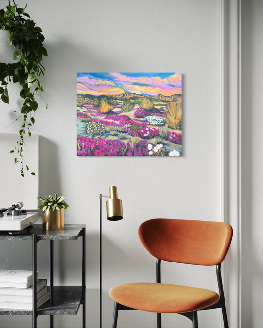 Colorful flower desert landscape painting on a wall above a modern chair and side table.