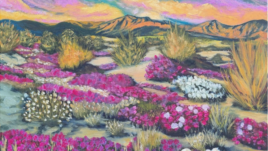 Desert landscape with colorful flowers and mountains in the background