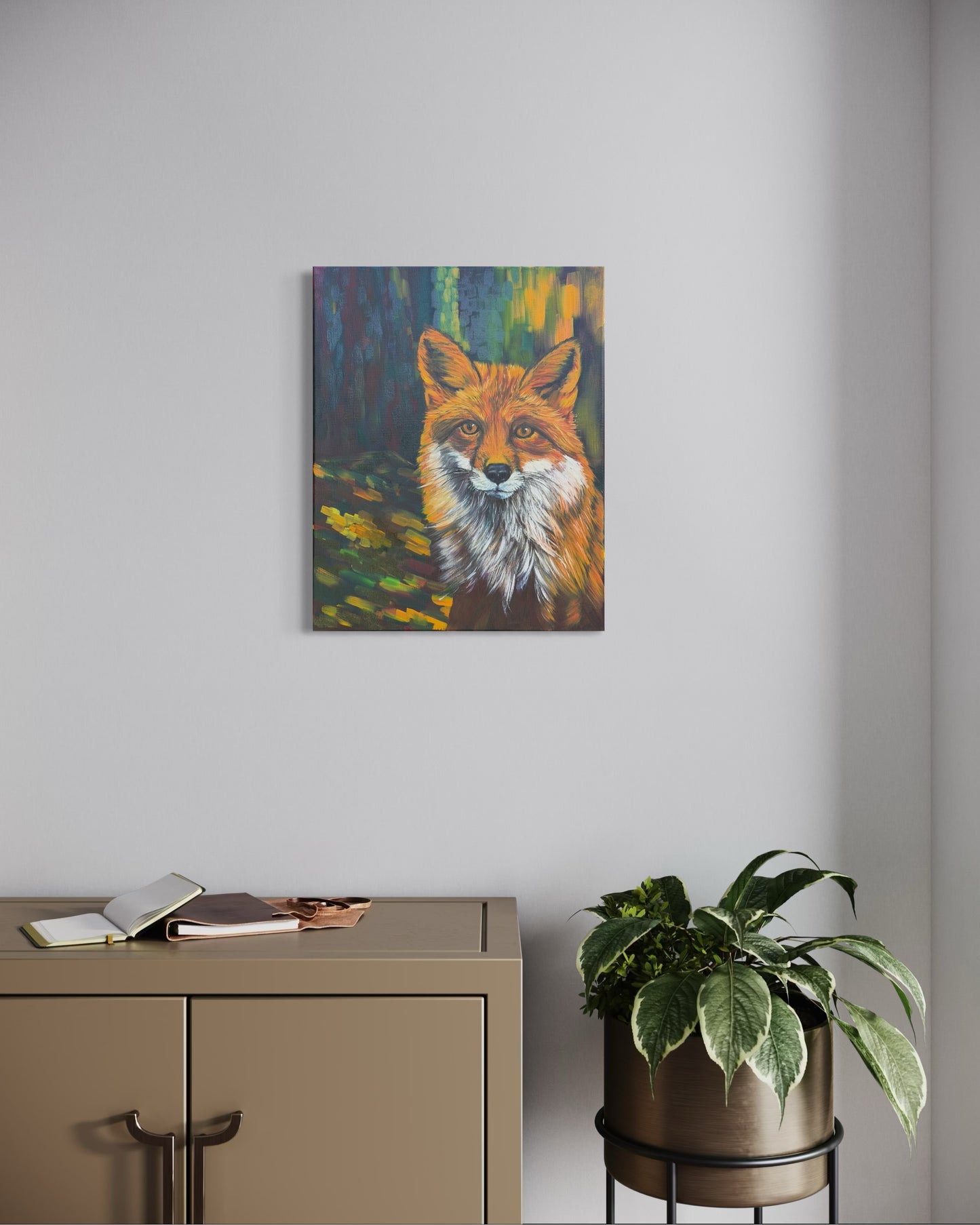 Painting of a red fox on a wall above a desk with a plant.