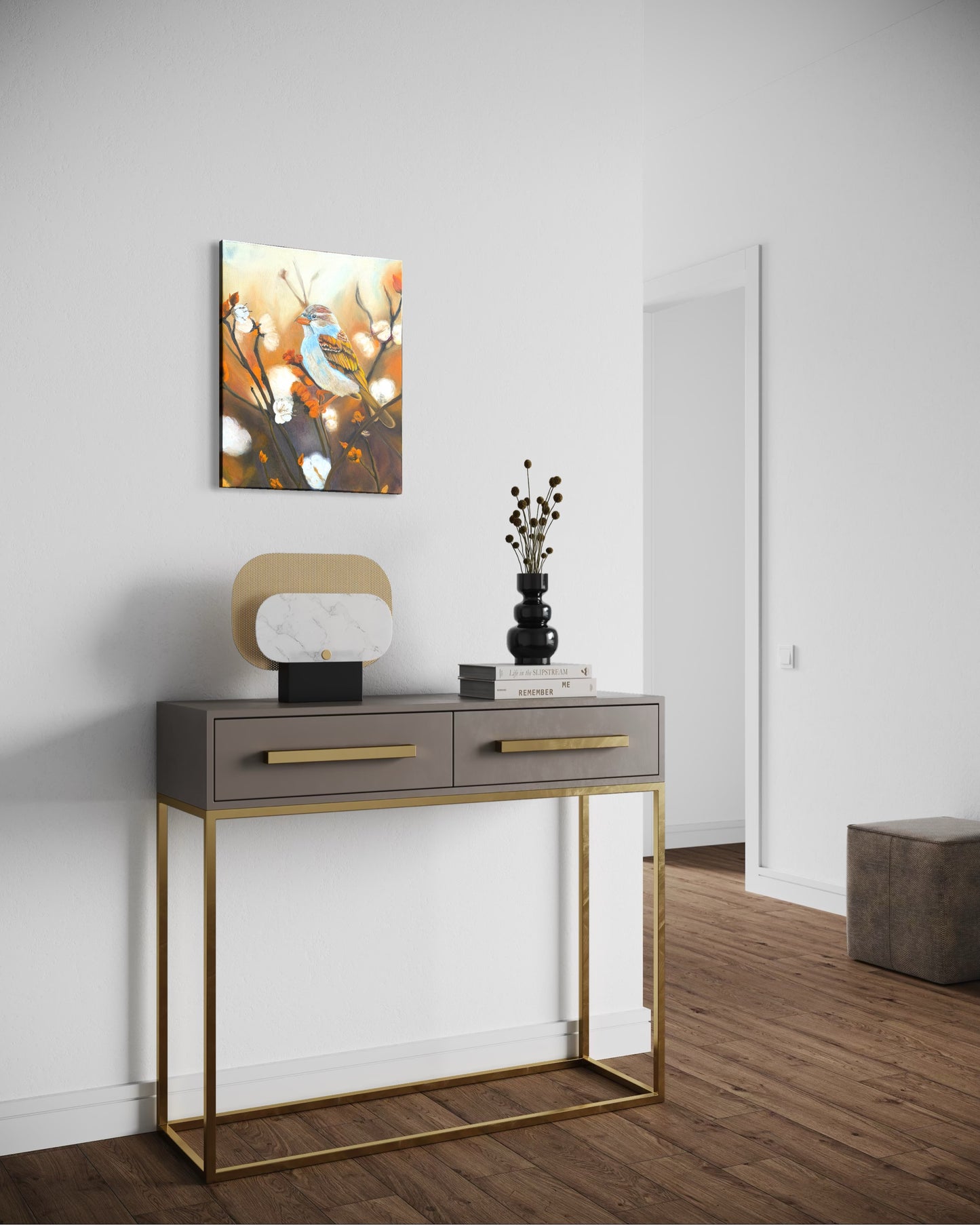 Console table with decorative items against a white wall and a oil painting of a sparrow bird